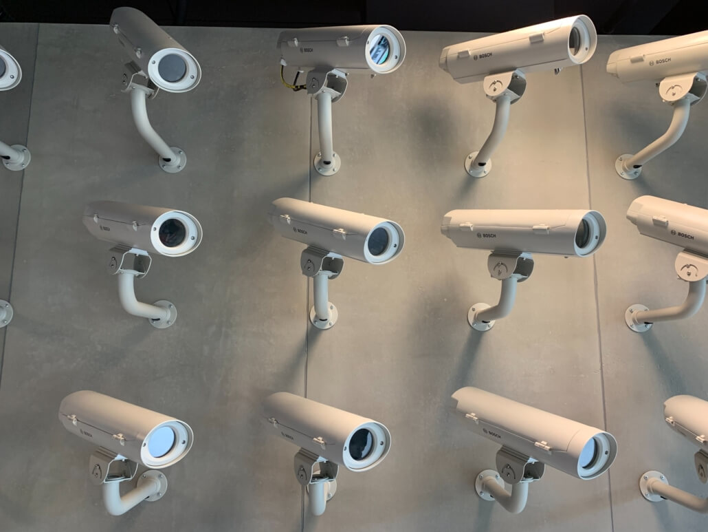 Security cameras mounted close together on a wall